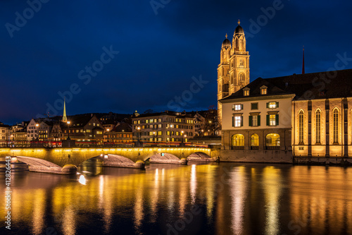 M  nsterbr  cker bridge and Kirche Fraum  nster at night in Z  rich city in Switzerland