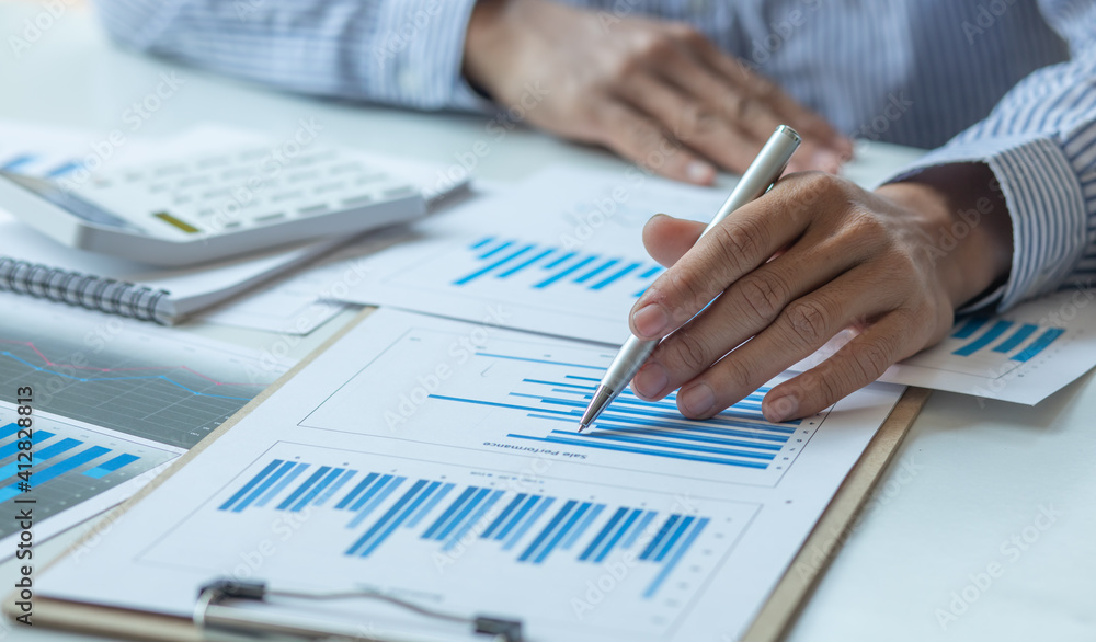 Financial Business man analyze the graph of the company's performance to create profits and growth, Market research reports and income statistics, Financial and Accounting concept. Financial Business man analyze the graph of the company's performance to create profits and growth, Market research reports and income statistics, Financial and Accounting concept.