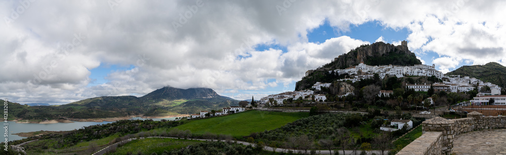 Naklejka premium panorama view of the whitwashed Andalusian village of Zahara de la Sierra and its Moorish Castle on the hilltop