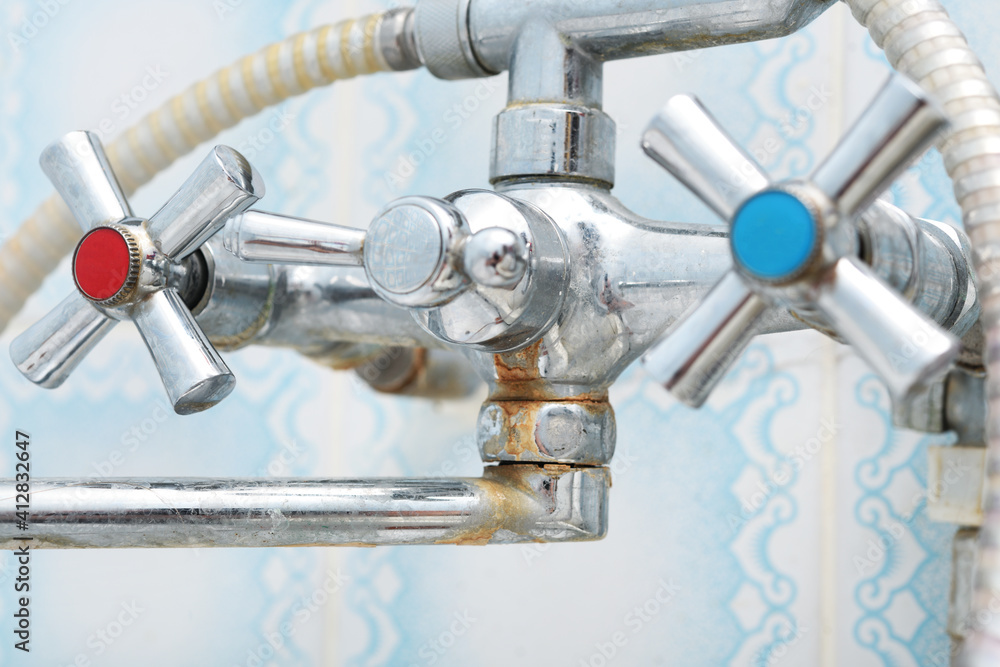 Dirty calcified shower mixer tap, faucet with limescale on it, close up Dirty calcified shower mixer tap, faucet with limescale on it, close up