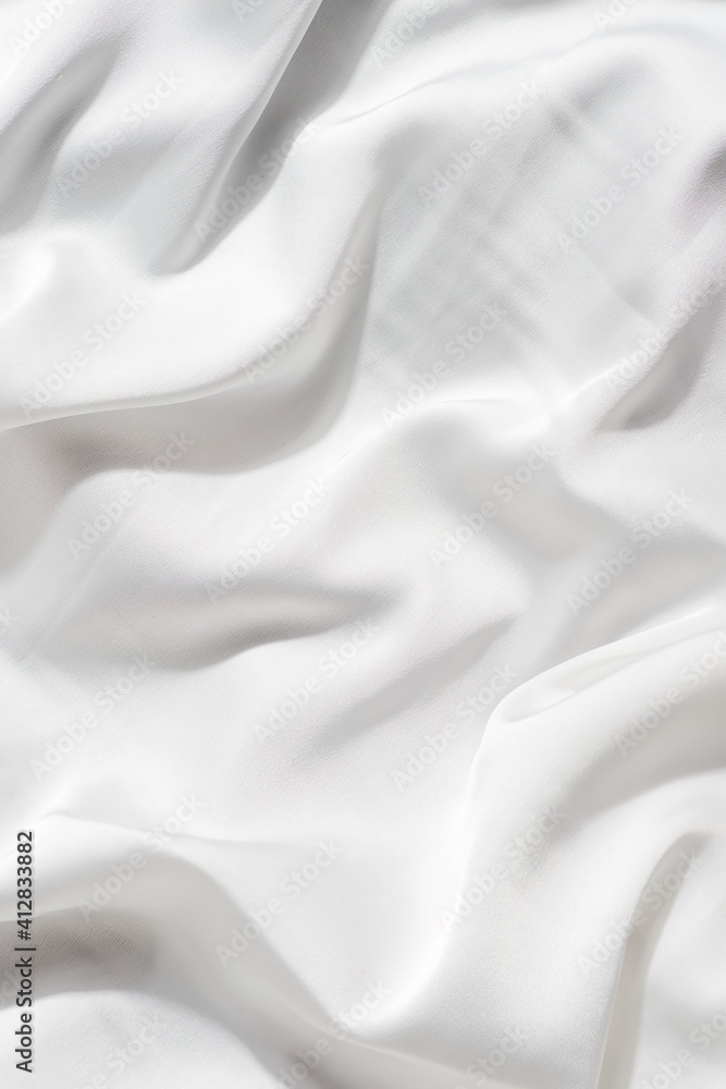 Obraz premium beautiful silk fabric of delicate white color draped with small folds, softly flowing,