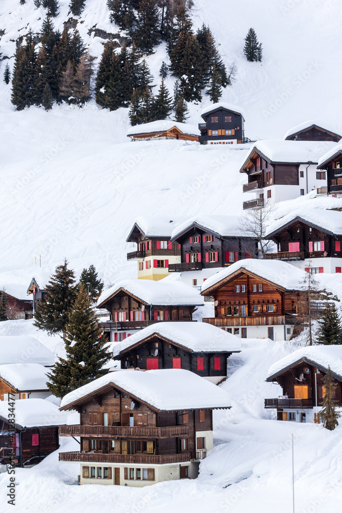 Wood chalets on the snow mountain in winter resort Riederalp, Switzerland.