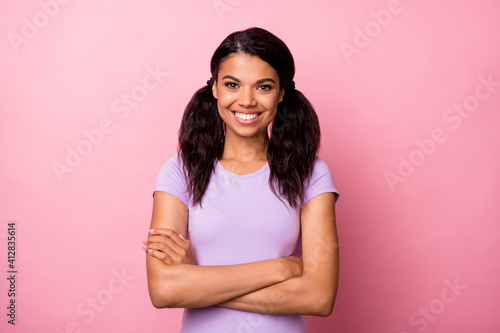 Photo of afro american confident happy woman crossed hands good mood isolated on pastel pink color background