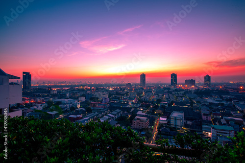 The high angle background of the city view with the secret light of the evening  blurring of night lights  showing the distribution of condominiums  dense homes in the capital community