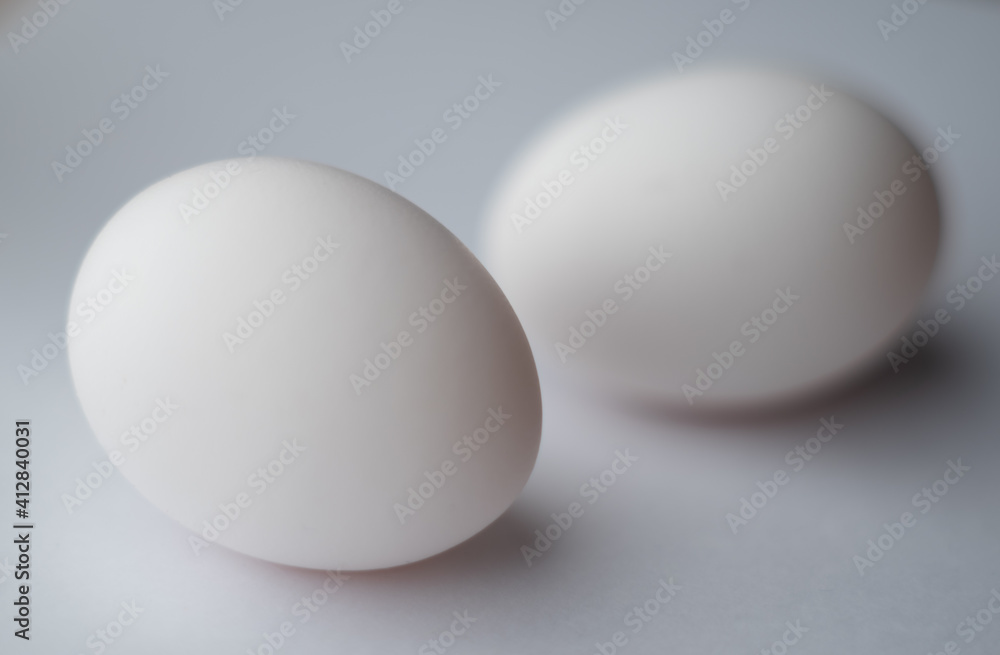 two eggs, one out of focus two eggs, one out of focus