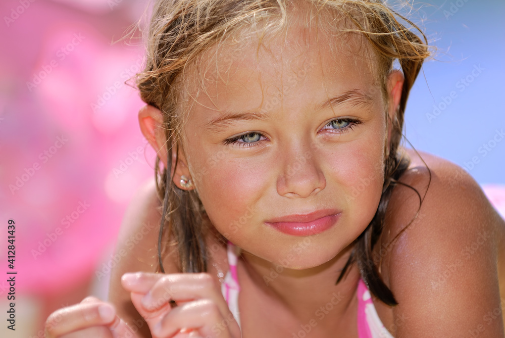 Little blonde girl in swimsuit on the beach foto de Stock Adobe Stock