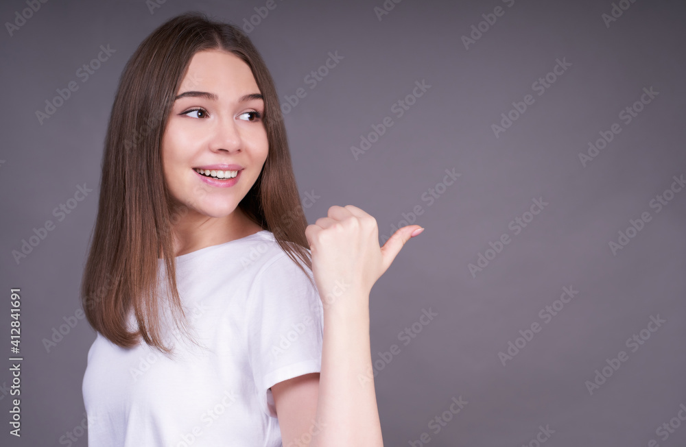 Cute young Caucasian girl showing to the side and looking back. Cute young Caucasian girl showing to the side and looking back.