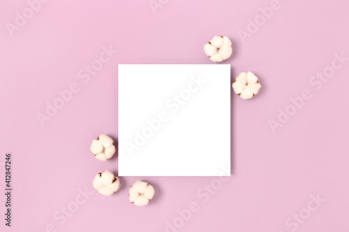 Square paper card mockup with frame made of cotton on a purple pastel background. Eco concept. © rorygezfresh