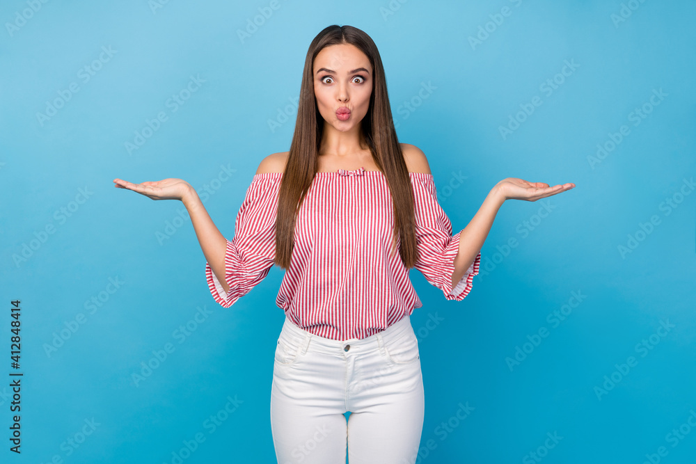 Portrait romantic girl hold hand present 14-february dating product send air kiss wear white pants isolated blue color background Portrait romantic girl hold hand present 14-february dating product send air kiss wear white pants isolated blue color background