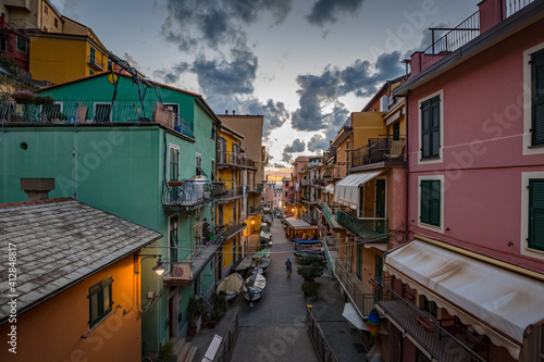 MANAROLA, ITALY - OCTOBER, 2020: cityscape. Walking Manarola village in Cinque Terre on the Italian Riviera at sunset lights