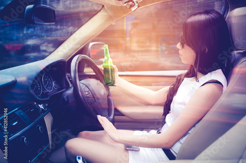 Drunk woman driving a car at night time © Creativa Images