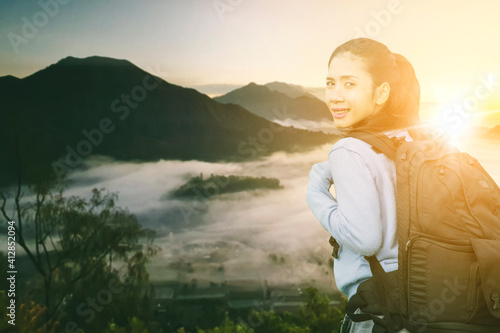 Wallpaper Mural Female hiker standing on mountain peak at sunrise Torontodigital.ca