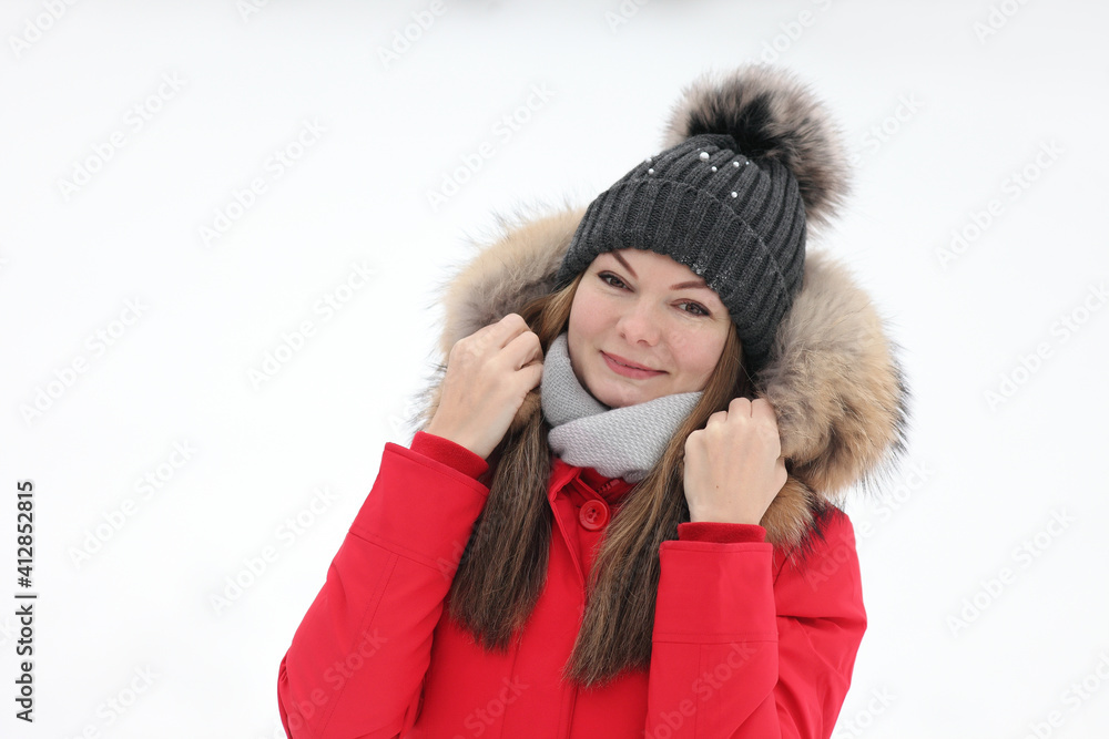 woman in a red jacket in winter on a background of snow woman in a red jacket in winter on a background of snow