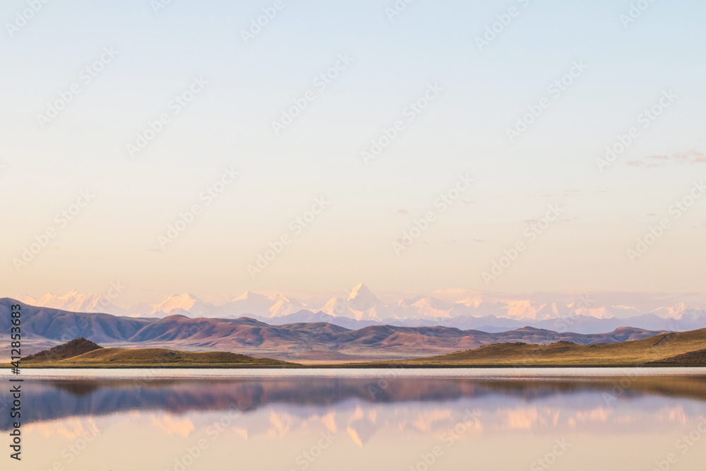 Lake Tuzkol in Kazakhstan and a view of Khan Tengri peak at sunrise