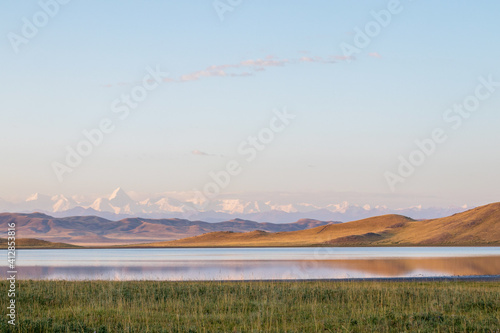 Lake Tuzkol in Kazakhstan and a view of Khan Tengri peak at sunrise photo