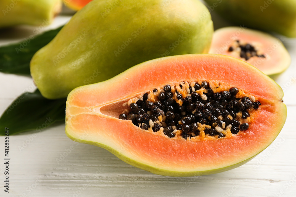 Fresh ripe papaya fruits on white table, closeup Fresh ripe papaya fruits on white table, closeup