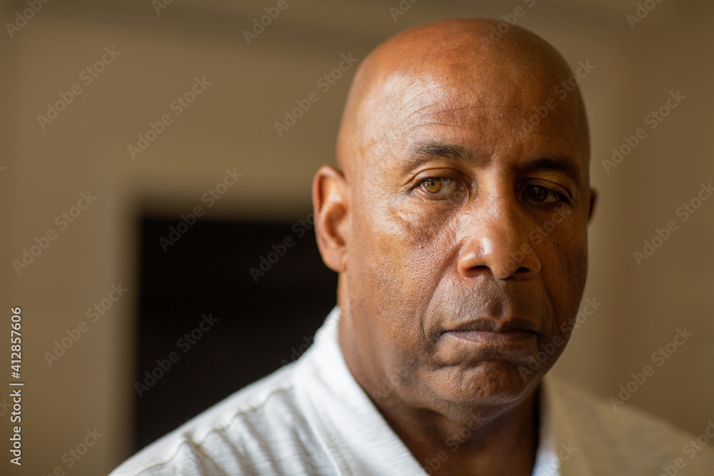 Senior African American man looking not smiling and looking depressed. Senior African American man looking not smiling and looking depressed.