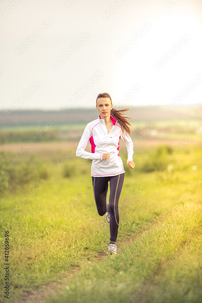 Running woman over grenn spring background