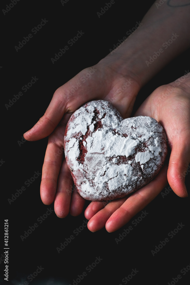 Tasty heart shape form cookies on background table. Homemade red cookie with sugar icing. St.Valentine sweets. Close up view delicious sweet dessert Tasty heart shape form cookies on background table. Homemade red cookie with sugar icing. St.Valentine sweets. Close up view delicious sweet dessert
