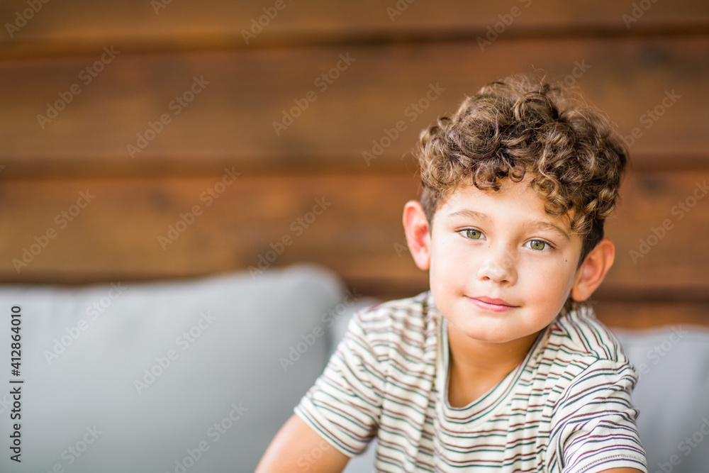 Handsome young boy with curly hair smiling. Handsome young boy with curly hair smiling.