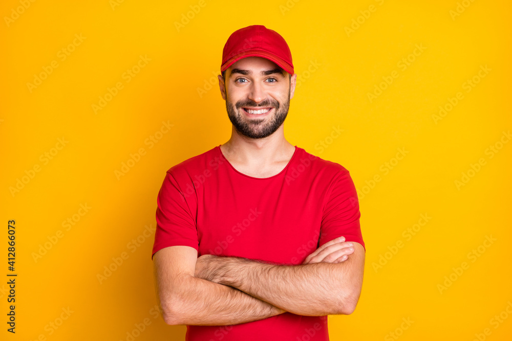 Portrait of attractive content virile cheerful guy mailman folded arms isolated over vibrant yellow color background Portrait of attractive content virile cheerful guy mailman folded arms isolated over vibrant yellow color background