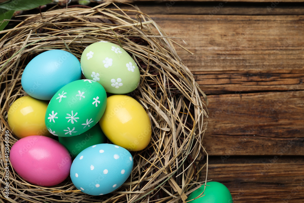 Colorful eggs in nest on wooden background. Happy Easter Colorful eggs in nest on wooden background. Happy Easter