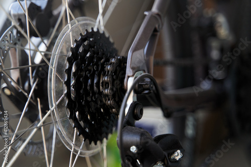 Mountain bike rear derailleur close-up. Rear racing bike cassette on the wheel with chain.