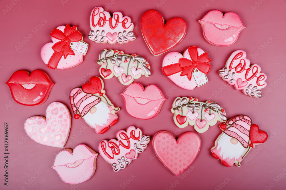 Closeup of variation of different cookies for valentine's day. Heart, love and kiss cookie on pink background. Present gift or background for Valentine or Mother's day. Lovely sweet gift or postcard Closeup of variation of different cookies for valentine's day. Heart, love and kiss cookie on pink background. Present gift or background for Valentine or Mother's day. Lovely sweet gift or postcard
