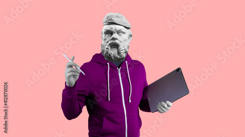 Modern art collage. Concept portrait man holding tablet and pencil. Gypsum head of Socrates.