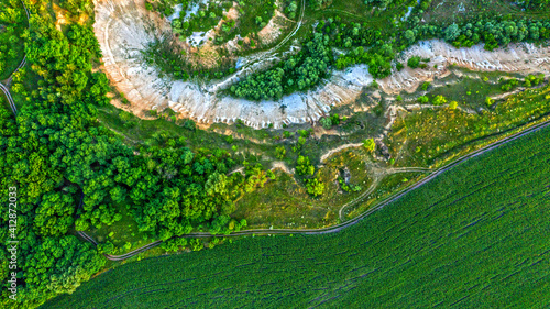 Aerial drone view - Beautiful summer landscape old chalk quarry. Bird view over nature landscape with old chalk quarry. Green summer landscape from the top view.