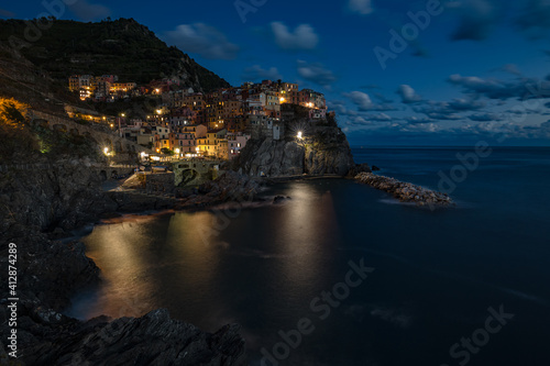 Manarola village at sunset on Mediterranean sea in National park Cinque Terre, La Spezia, Liguria, Italya