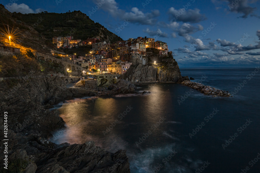 Manarola village at sunset on Mediterranean sea in National park Cinque Terre, La Spezia, Liguria, Italya Manarola village at sunset on Mediterranean sea in National park Cinque Terre, La Spezia, Liguria, Italya