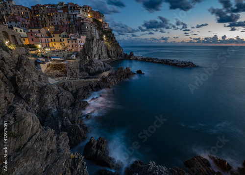 Manarola village at sunset on Mediterranean sea in National park Cinque Terre, La Spezia, Liguria, Italya