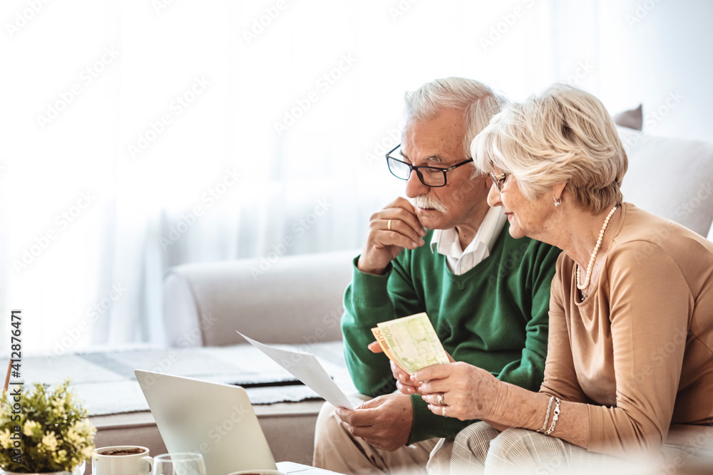  Senior couple having problems with home finances. Senior couple looking stressed while going over their finances at home