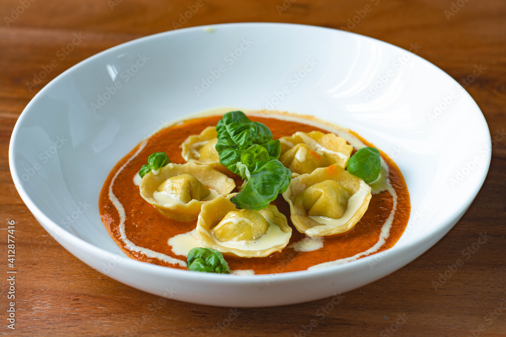 Handmade Tortelli with tomato sauce , basil and parmesan shavings. Revisited dish of Melanzane alla Parmigiana ( eggplant parmigiana) Handmade Tortelli with tomato sauce , basil and parmesan shavings. Revisited dish of Melanzane alla Parmigiana ( eggplant parmigiana)