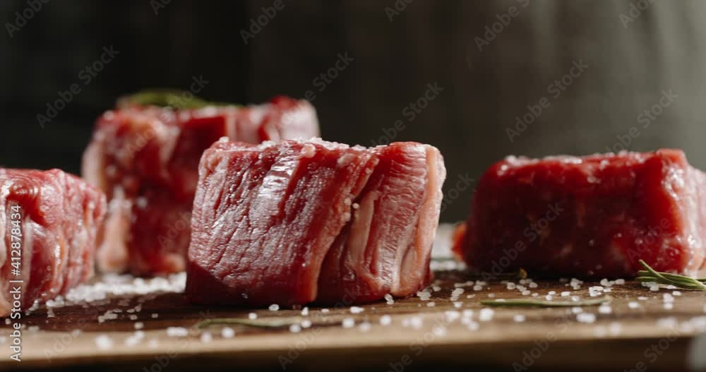 Close up shot of a juicy grilled steak on chef's preparation table. Smoke rising from big piece of tasty meat. Close up shot of a juicy grilled steak on chef's preparation table. Smoke rising from big piece of tasty meat.