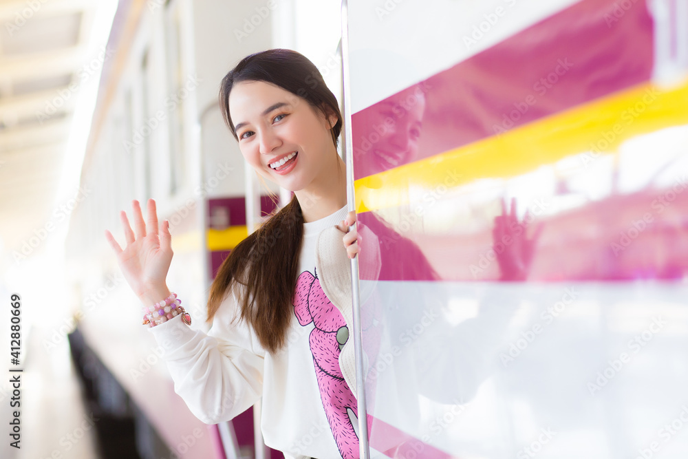 Asian beautiful woman say bye bye to her family due to working in the city by train or she arrive say welcome to home at the station. Asian beautiful woman say bye bye to her family due to working in the city by train or she arrive say welcome to home at the station.
