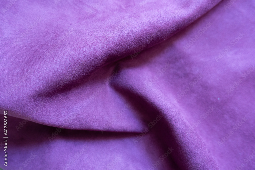 Folded violet faux suede fabric from above Folded violet faux suede fabric from above