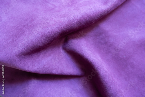 Folded violet faux suede fabric from above