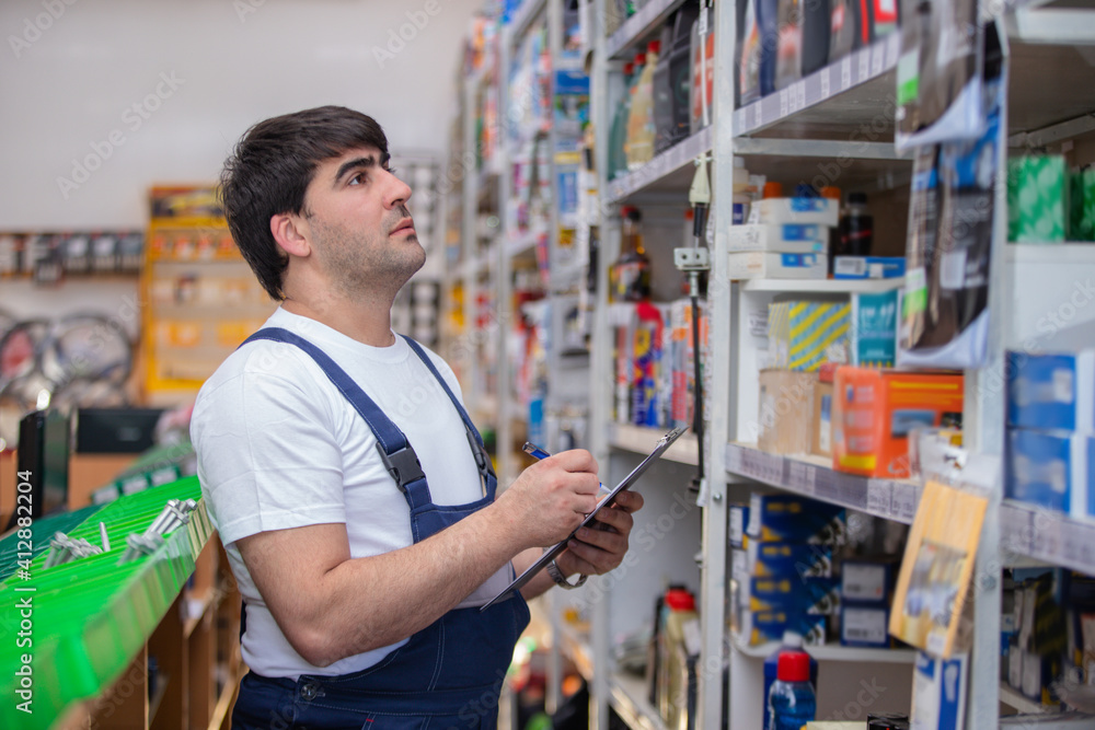 The auto parts dealer selects the spare part and writes the information to the tablet. The auto parts dealer selects the spare part and writes the information to the tablet.