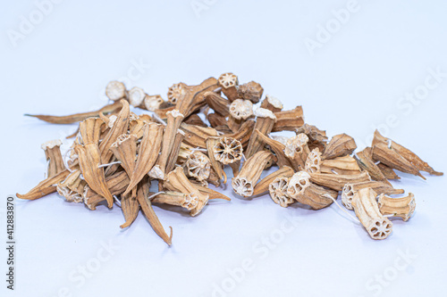 Dried okras on a white background. Dry okras on string.
