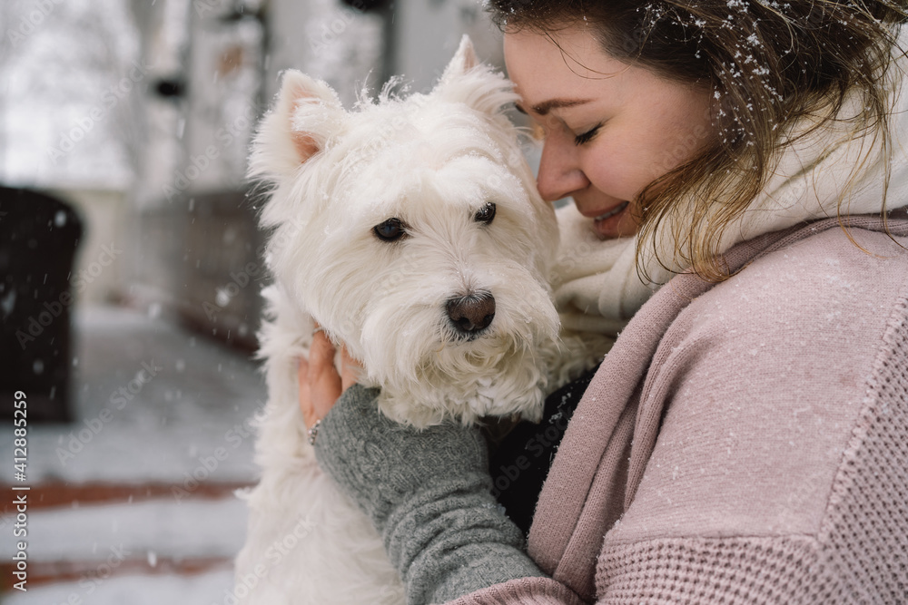 Nice laughing girl hugging adorable white dog with funny cute emotions. Nice laughing girl hugging adorable white dog with funny cute emotions.