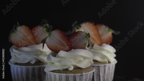 Three cupcakes decorated with delicious strawberries. Fresh strawberries.