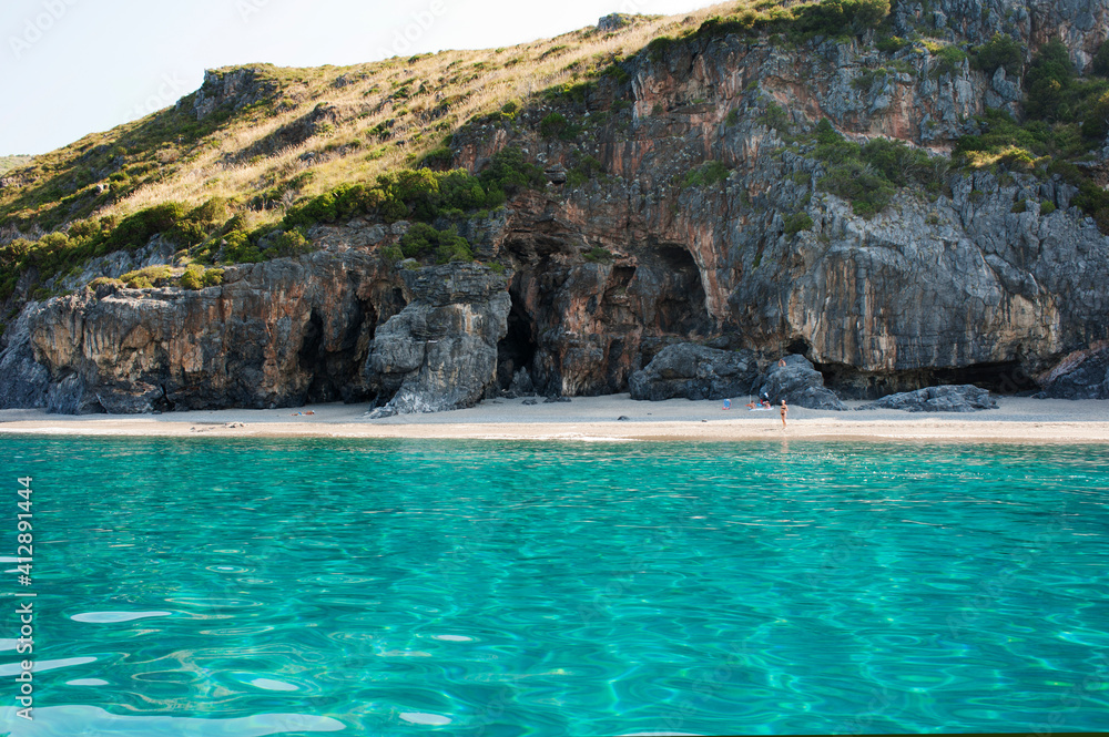One of the long but narrow sandy shore dominated by the high rocky cliff of Capo Palinuro, Italy. One of the long but narrow sandy shore dominated by the high rocky cliff of Capo Palinuro, Italy.