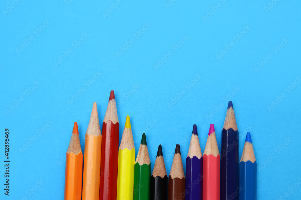 color pencils on a blue background close up color pencils on a blue background close up