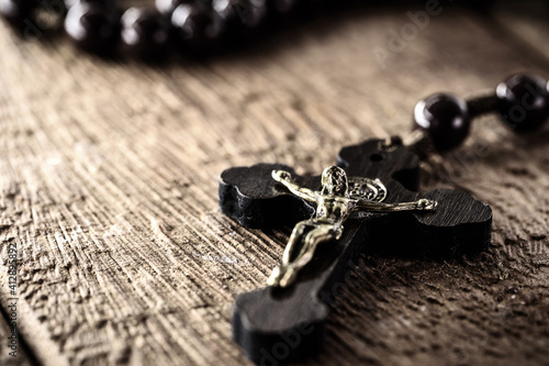 rustic wooden rosary, handmade, on wooden background, space for text
