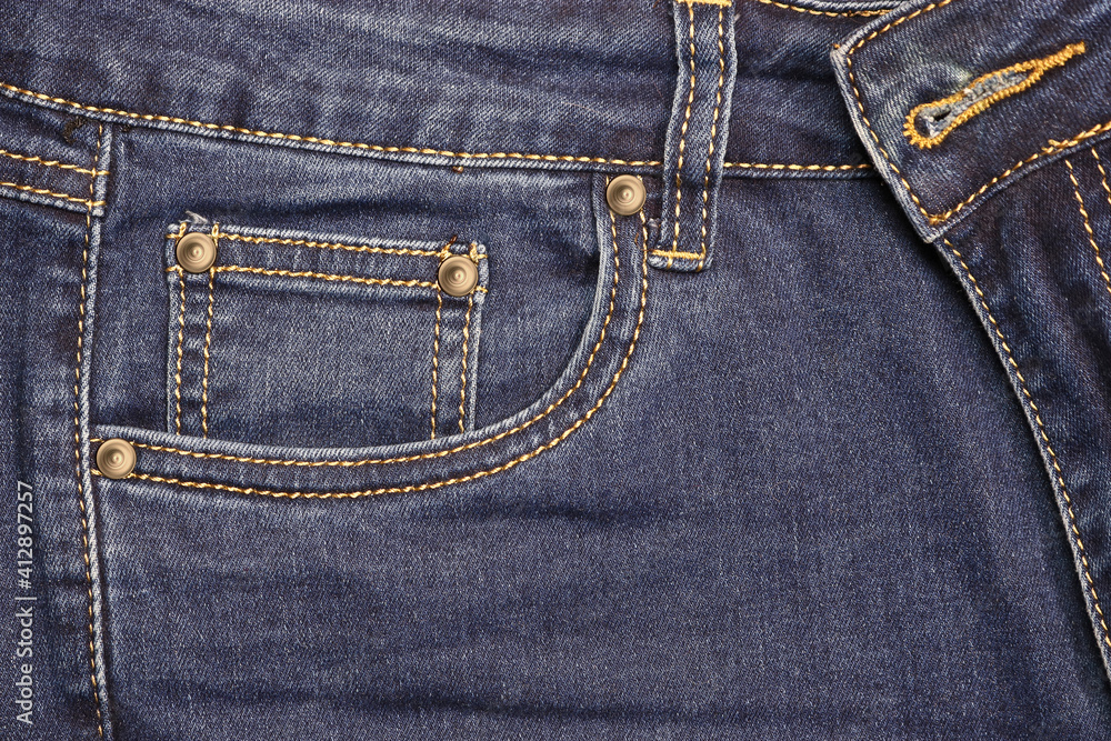 Thread-stitched front pocket of blue fashion jeans with studs. Thread-stitched front pocket of blue fashion jeans with studs.