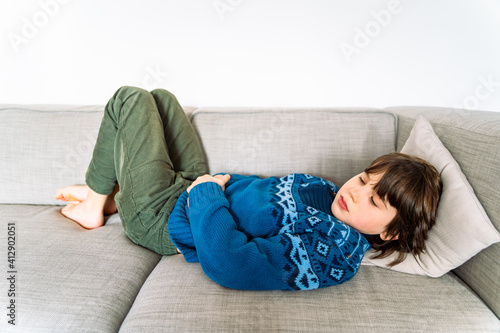 sick child, stomach pain, unhappy, quarantine, ill, after day, alone, boy, casual, caucasian, cheerful, child, childhood, children, couch, covid, emotion, expression, expressions, face, family, guy, h