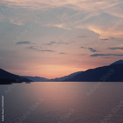 landscape with pink sunset. Seascape with mountains and cloudy sky