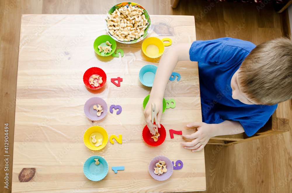 Little child doing simple math exercises. Early education, counting ...